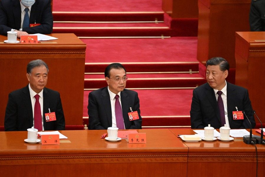 China's President Xi Jinping (right) looks at Premier Li Keqiang (centre) and Politburo Standing Committee member Wang Yang (left) during the closing ceremony of the 20th Chinese Communist Party's Congress at the Great Hall of the People in Beijing on 22 October 2022. (Noel Celis/AFP)