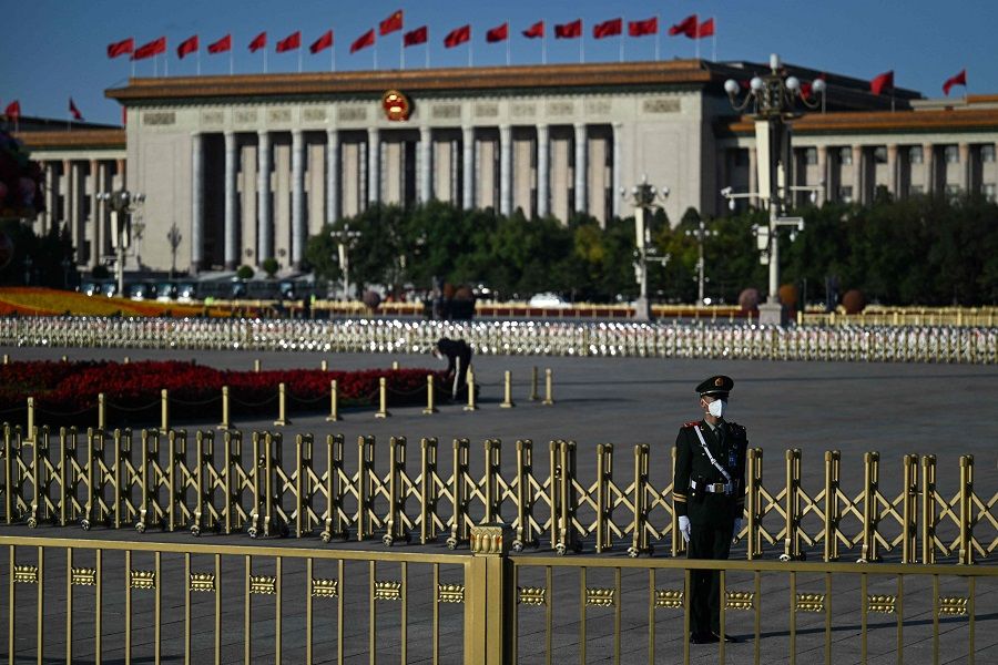 A member of the security staff keeps watch in front of the Great Hall of the People in Beijing, China, on 16 October 2022. (Noel CELIS/AFP)