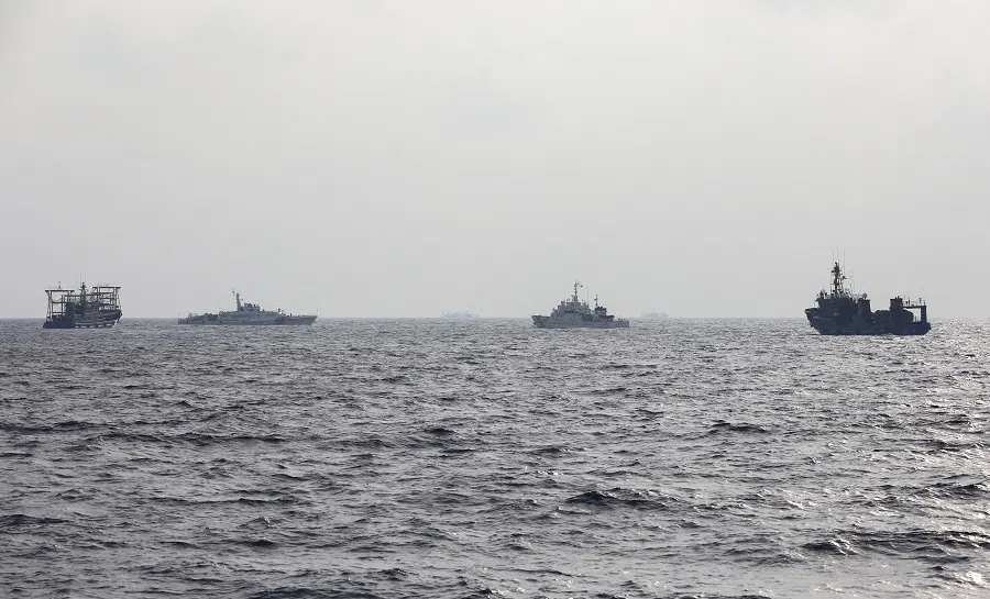 A Philippine Coast Guard ship is seen surrounded by Chinese maritime militia vessels and a Chinese Coast Guard ship during a resupply mission for Filipino troops stationed at a grounded warship in the South China Sea, on 4 October 2023.