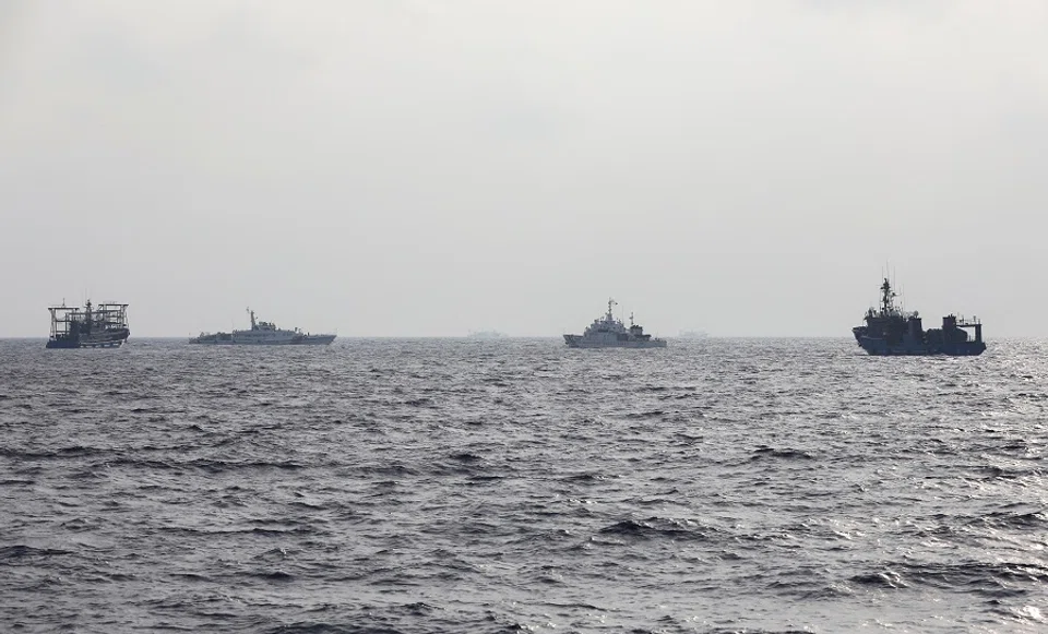 A Philippine Coast Guard ship is seen surrounded by Chinese maritime militia vessels and a Chinese Coast Guard ship during a resupply mission for Filipino troops stationed at a grounded warship in the South China Sea, on 4 October 2023. (Adrian Portugal/Reuters)