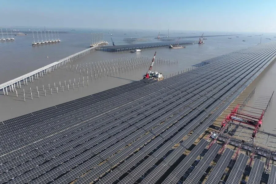 Aerial view of solar panels under construction at a photovoltaic project in a coastal tidal zone in Lianyungang, Jiangsu province, China, on 4 December 2025. (STR/AFP)