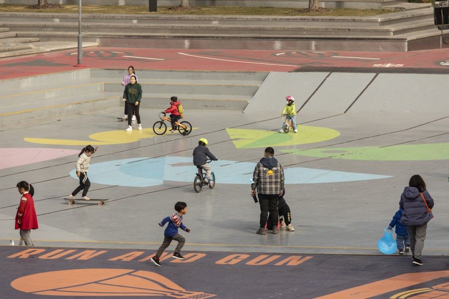 Children play at a park near a riverside boardwalk in Shanghai, China, on 16 January 2022. (Qilai Shen/Bloomberg)