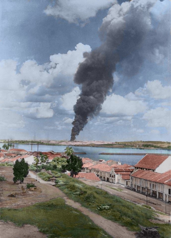In February 1942, Japanese troops reached Johor in the south of the Malay Peninsula, and began bombarding Singapore across the strait. This image shot from Johor by a journalist shows Singapore under fire.