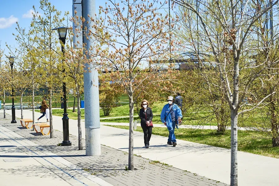 Pedestrians wearing protective masks walk through Berry Lane Park in Jersey City, New Jersey, US, on 28 April 2020. (Gabby Jones/Bloomberg)