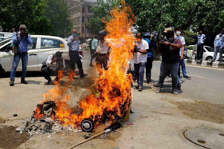 Protesters burn China-made goods at a demonstration requesting consumers to boycott Chinese goods organised by the Confederation of All India Traders (CAIT) at Karol Bagh market in New Delhi, India, on 22 June 2020. (T. Narayan/Bloomberg)
