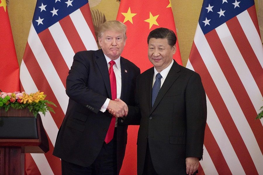 A new Cold War between the US and China will involve a contest of ideologies. Pictured here is a file photo taken on 9 November 09 2017 of US President Donald Trump (L) shaking hands with China's President Xi Jinping during a press conference at the Great Hall of the People in Beijing. (Nicolas Asfouri / AFP)