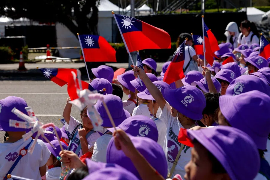 Children wave Taiwanese flags ahead of Taiwan's Double Ten Day celebrations in Taipei, Taiwan, 9 October 2025. (Ann Wang/Reuters)