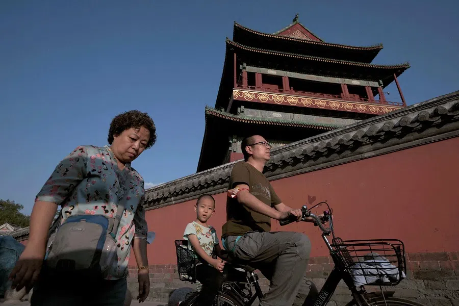 People walk in front of the Drum Tower in Beijing, China, on 14 September 2022. (Noel Celis/AFP)