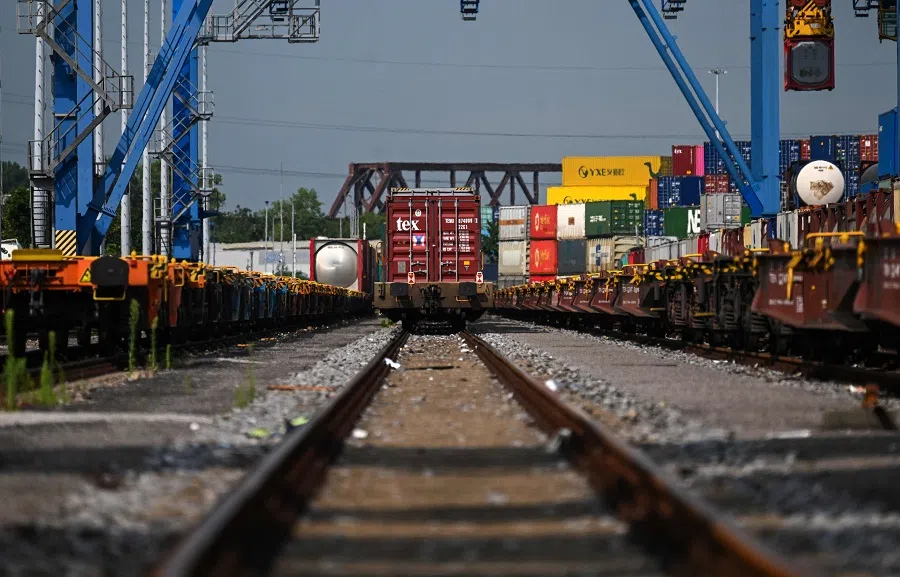 Containers are loaded from the railway at the seaport terminal DIT Duisburg Intermodal Terminal at the Duisburg harbour, on 13 July 2023. With the expansion of rail-bound freight traffic along the "new Silk Road", the port continues to expand its role as a hub or end point of the Silk Road, which connects China and numerous other Asian countries with the Port of Duisburg. (Ina Fassbender/AFP)