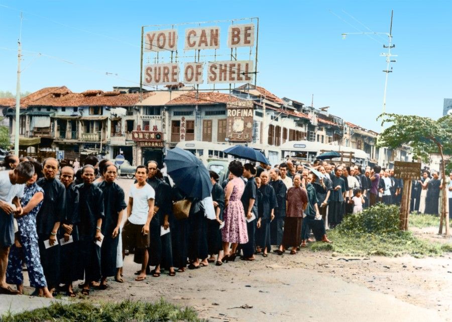 A charity organisation distributing supplies in the early 1950s, with many elderly women in the collection queue. The community gradually picked itself up from post-war chaos and poverty.