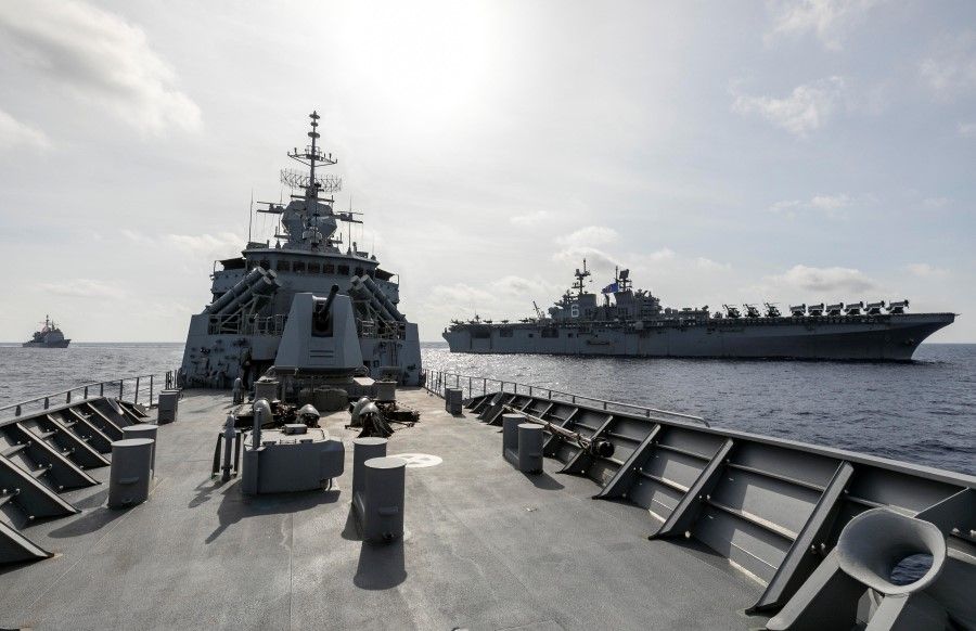 HMAS Parramatta (C) breaks away from USS America (R) and USS Bunker Hill (L) on completion of officer of the watch manoeuvres in the South China Sea, in this 18 April 2020 handout photo. (Australia Department Of Defence/Handout via REUTERS)
