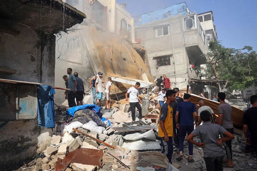 People search for survivors in the rubble of a building following Israeli bombardment at Al-Bureij refugee camp in the central Gaza Strip on 15 June 2024. (Eyad Baba/AFP)