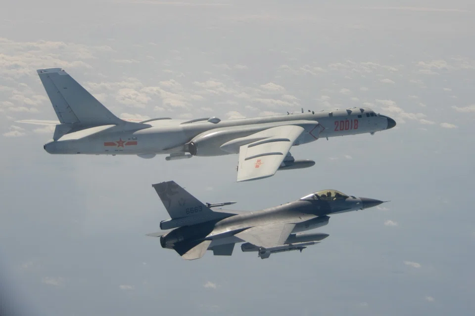 This handout photo taken and released on 10 February 2020 by Taiwan's Defense Ministry shows a Taiwanese F-16 fighter jet flying next to a Chinese H-6 bomber (top) in Taiwan's airspace. (Handout/Taiwan's Defense Ministry/AFP)