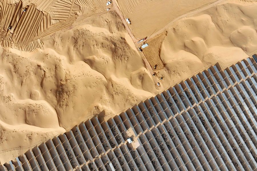In this photo taken on 9 December 2023, vehicles are seen next to a field of solar panels during construction at a new energy base in China's northern Ningxia region. (AFP)