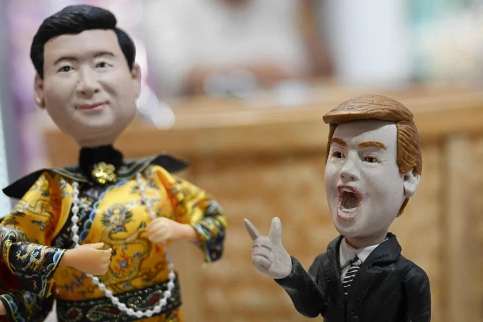 Plastic figures depicting China's President Xi Jinping (L) dressed as a Qing dynasty emperor and US President Donald Trump (R) are displayed for sale in a store in Beijing on 10 May 2026. (Pedro Pardo/AFP)