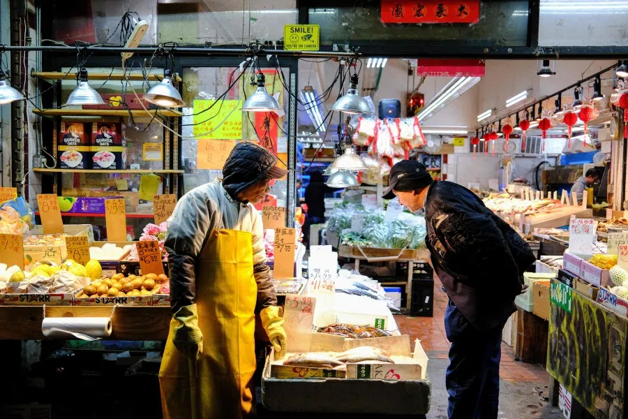 People shop at a food market in the Chinatown area of Manhattan in New York City on 30 November 2025. (Charly Triballeau/AFP)