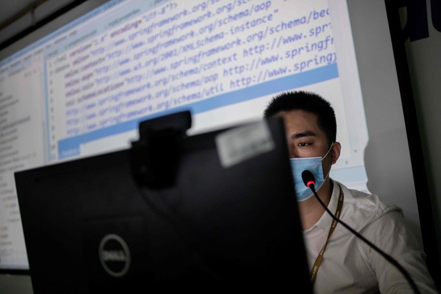 An instructor teaches an online coding class at Tarena International's Zhongguancun campus in Beijing on 24 July 2020. (Nicolas Asfouri/AFP)