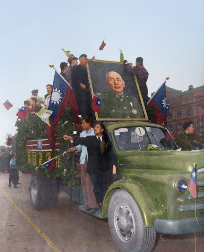 "Anti-communist heroes" parade on the streets in trucks, 1954. Excited crowds also climb onto the trucks to celebrate with the heroes, who hold up portraits of Chiang Kai-shek and wave flags.