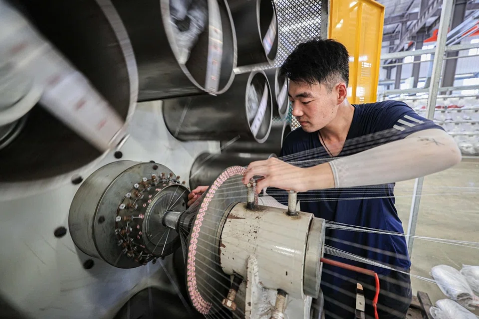 An employee works on a production line of tubular products for export at a factory in Lianyungang, in eastern China’s Jiangsu province on 8 July 2025. (AFP)