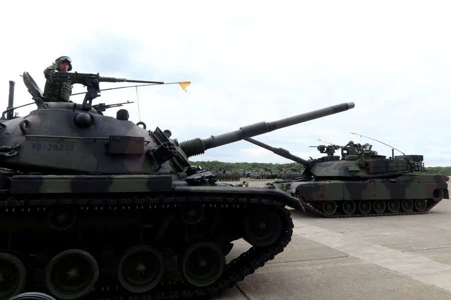 A CM-11 Brave Tiger tank and an M1A2T Abrams tank take part in a commissioning ceremony for Taiwan's first battalion of M1A2T Abrams tanks, at the Hukou military base in Hsinchu, Taiwan, 31 October 2025. (Yi-Chin Lee/Reuters)