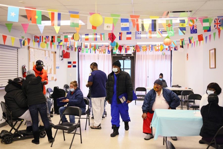 People are checked in to receive the Moderna coronavirus (Covid-19) vaccine at Red Hook Neighborhood Senior Center in the Red Hood neighbourhood of the Brooklyn borough on 22 February 2021 in New York City. (Michael M. Santiago/AFP)