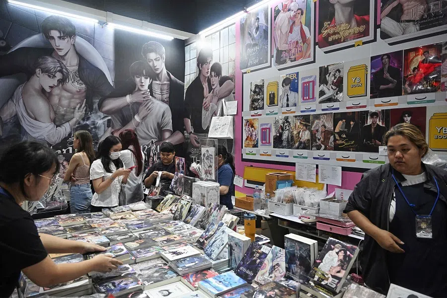 Readers browse through BL (“Boys’ Love”) series books at the 29th Book Expo Thailand 2024 at Queen Sirikit National Convention Center in Bangkok on 11 October 2024. (Lillian Suwanrumpha/AFP)