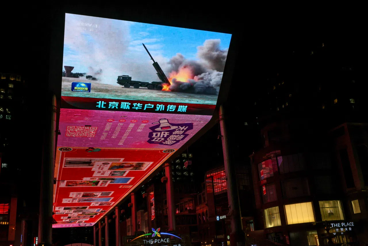 A giant screen shows a news report on China's "Justice Mission 2025" military drills around Taiwan, in Beijing, China, 30 December 2025.