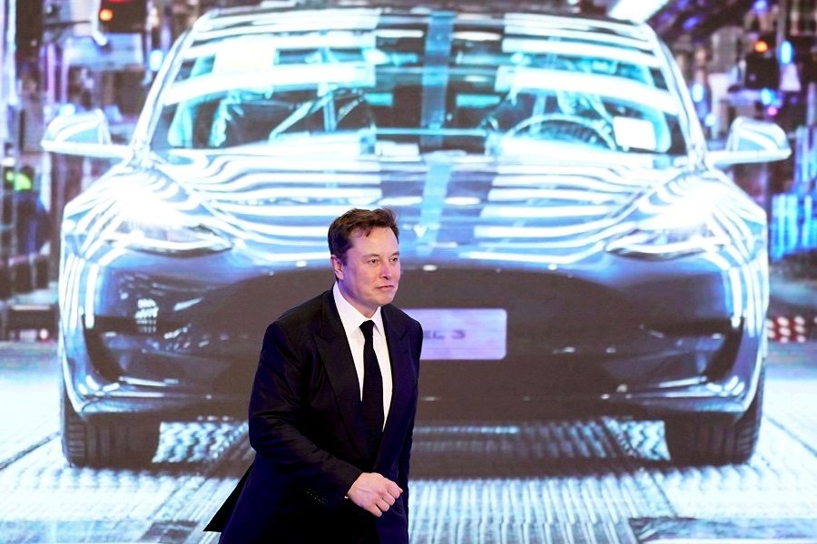 Tesla Inc CEO Elon Musk walks next to a screen showing an image of Tesla Model 3 car during an opening ceremony for Tesla's China-made Model Y program in Shanghai, China, 7 January 2020. (Aly Song//File Photo/Reuters)