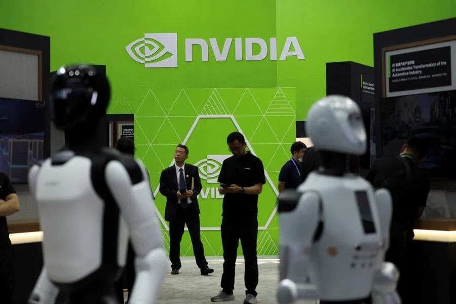 People stand near humanoid robots on display at the Nvidia booth during the China International Supply Chain Expo (CISCE) in Beijing, China, on 22 June 2026.