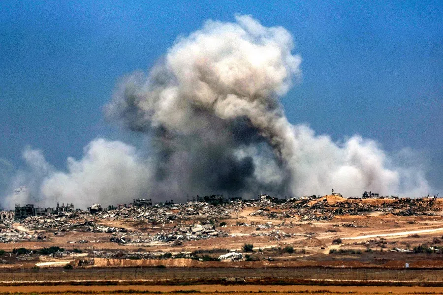 A plume of smoke erupts during Israeli bombardment in the Gaza Strip as pictured from across the border in southern Israel on 5 June 2025, amid the ongoing war between Israel and Hamas. Gaza’s civil defence agency said Israeli strikes killed at least ten people in the battered Palestinian territory on 5 June as the military keeps up an intensified offensive.  (Jack Guez/AFP)
