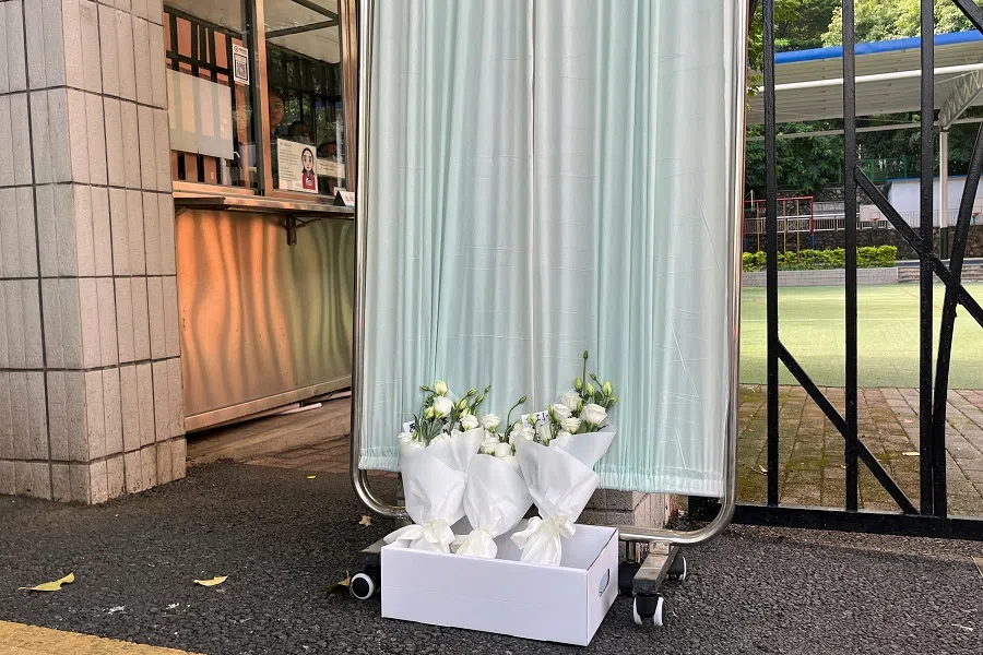 Flower bouquets lay outside Shenzhen Japanese School, following the death of a 10-year-old child after being stabbed by an assailant on the way to the school, in Shenzhen, Guangdong province, China, 19 September 2024. (David Kirton/Reuters)