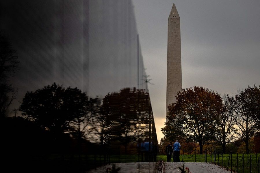 In this file photo taken on 10 November 2020, two Vietnam veterans walk towards the Washington Monument from the Vietnam Veterans Memorial Wall on Veterans Day in Washington, DC. (Samuel Corum/Getty Images North America/AFP)