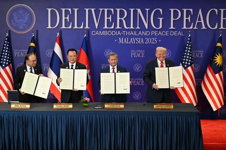 Malaysian Prime Minister Anwar Ibrahim, Thai Prime Minister Anutin Charnvirakul, Cambodian Prime Minister Hun Manet and US President Donald Trump hold up documents after the ceremonial signing of a ceasefire agreement between Thailand and Cambodia on the sidelines of the 47th ASEAN Summit in Kuala Lumpur on 26 October 2025. (Mohd Rasfan/Pool via AFP)