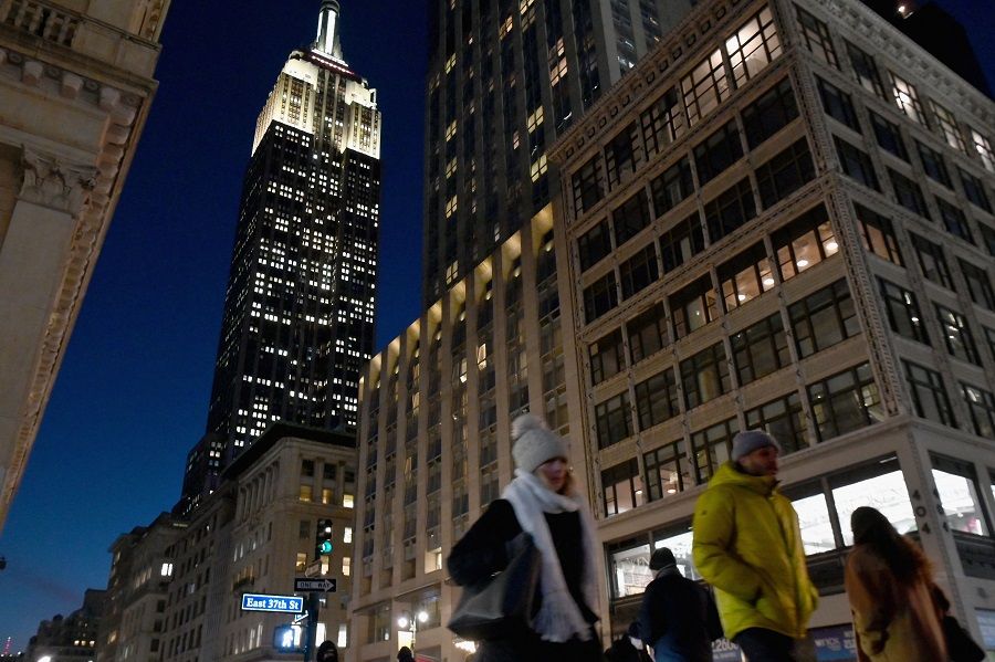 People walk near the Empire State Building in New York City, US, on 31 January 2022. (Angela Weiss/AFP)