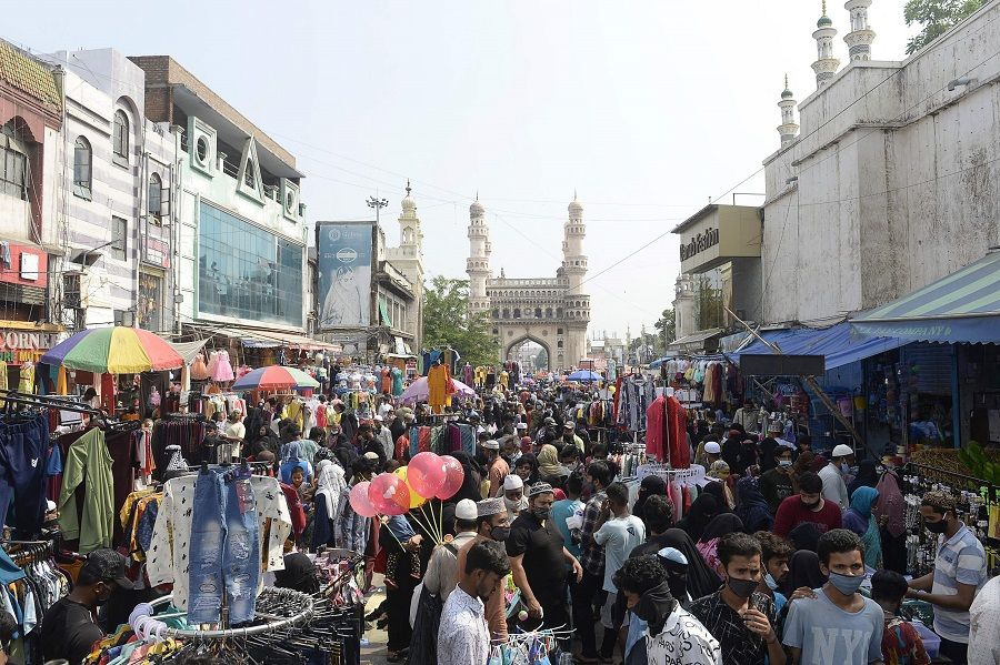 People gather at a market during relaxation for all activities on the occasion of Eid al-Fitr, in front of historical monument Charminar in the old city of Hyderabad, India, on 13 May 2021. (Noah Seelam/AFP)