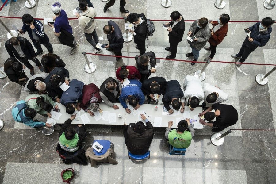People fill consent forms at a Covid-19 vaccination centre in Shanghai, China, on 3 April 2021. (Qilai Shen/Bloomberg)