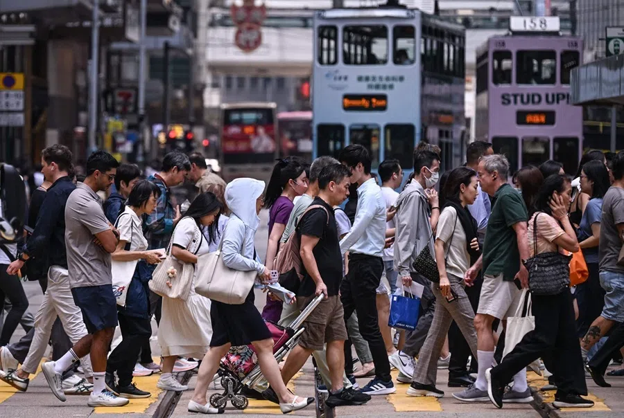 Pedestrians cross a street in Central Hong Kong on 16 September 2026.