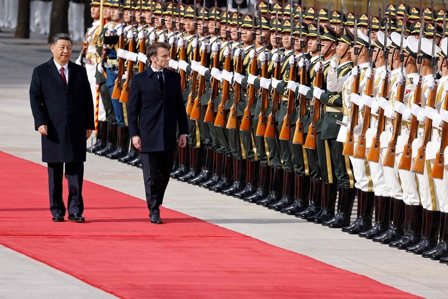 Chinese President Xi Jinping (left) and his French counterpart Emmanuel Macron review an honour guard during the official welcoming ceremony in Beijing, China, on 6 April 2023. (Ludovic Marin/AFP)