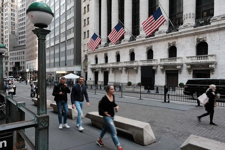 People walk by the New York Stock Exchange (NYSE) on 21 April 2023 in New York City, US. (Spencer Platt/Getty Images/AFP)