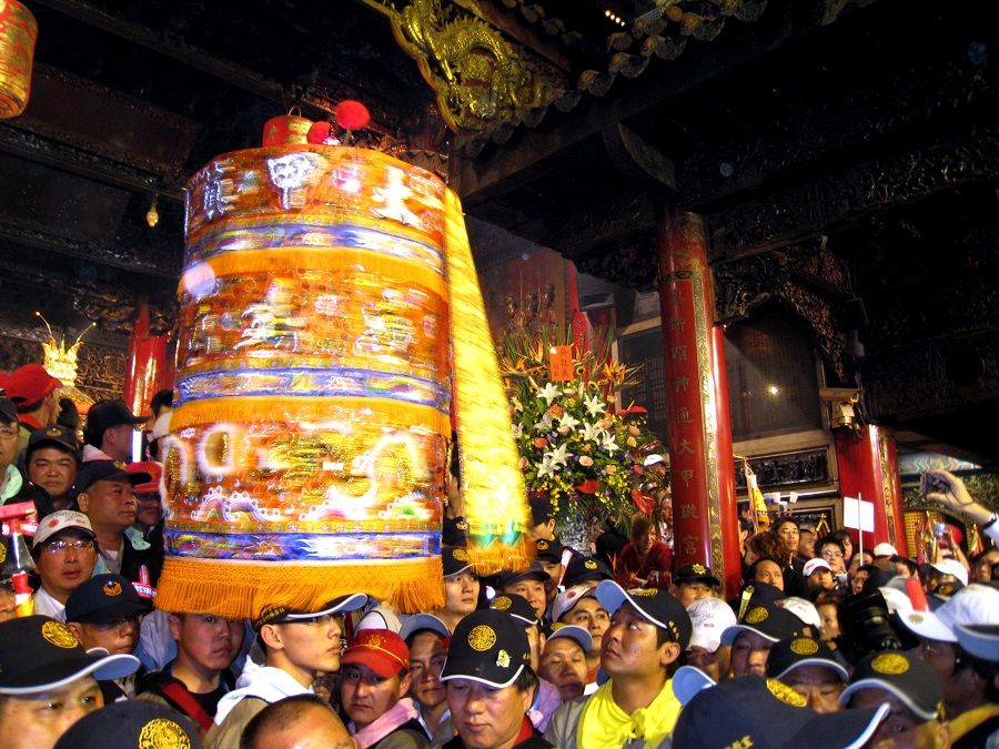 At the annual pilgrimage of goddess Dajia Mazu in Taiwan, worshippers carry an umbrella to 'keep' the goddess Mazu out of the sun. (SPH Media)