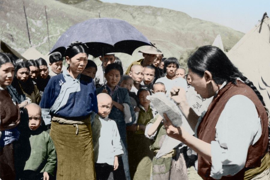 A resident of Lhasa reading a notification about the PLA entering Tibet, 1951.