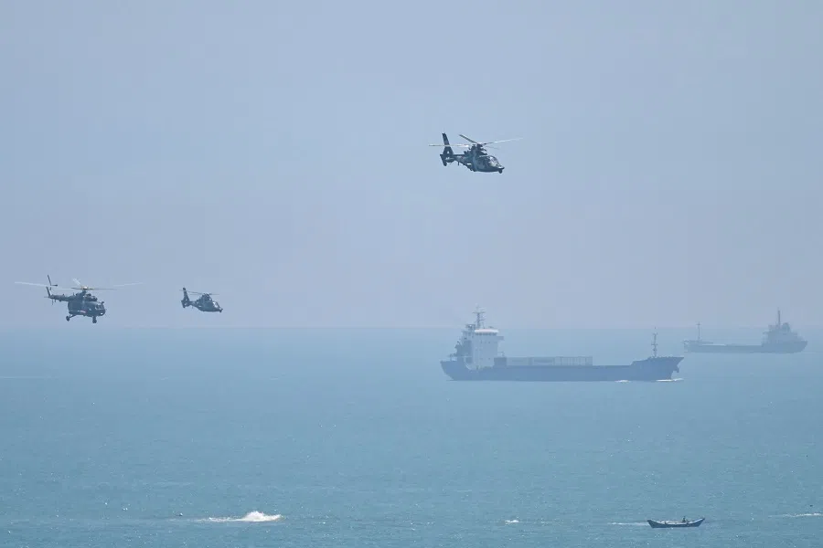In this file photo taken on 4 August 2022, Chinese military helicopters fly past Pingtan island, one of mainland China's closest point from Taiwan, in Fujian province ahead of massive military drills off Taiwan following US House Speaker Nancy Pelosi's visit to Taiwan. (Hector Retamal/AFP)
