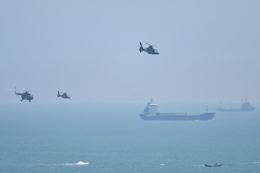 In this file photo taken on 4 August 2022, Chinese military helicopters fly past Pingtan island, one of mainland China's closest point from Taiwan, in Fujian province ahead of massive military drills off Taiwan following US House Speaker Nancy Pelosi's visit to Taiwan. (Hector Retamal/AFP)