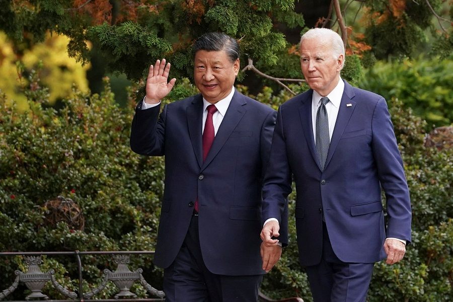 Chinese President Xi Jinping waves as he walks with US President Joe Biden at Filoli estate on the sidelines of the Asia-Pacific Economic Cooperation (APEC) summit, in Woodside, California, US, on 15 November 2023. (Kevin Lamarque/Reuters)