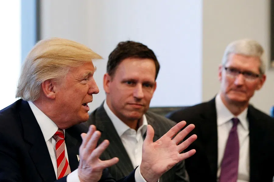 Donald Trump speaks as PayPal co-founder Peter Thiel (centre) and Apple Inc CEO Tim Cook (right) look on during a meeting with technology leaders at Trump Tower in New York, US, on 14 December 2016. (Shannon Stapleton/Reuters)