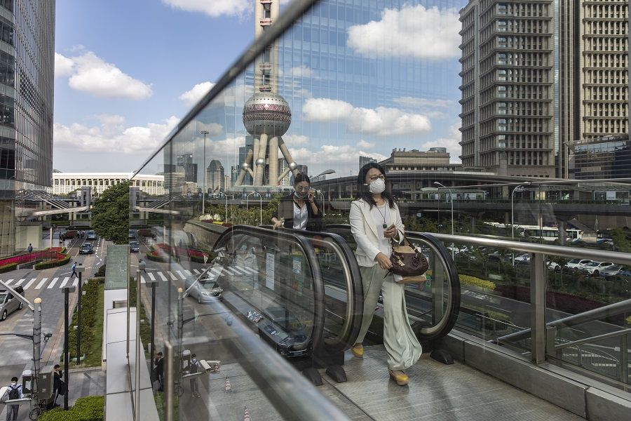 Morning commuters ride an escalator in the Lujiazui Financial District in Shanghai, China, on 9 October 2020. (Qilai Shen/Bloomberg)