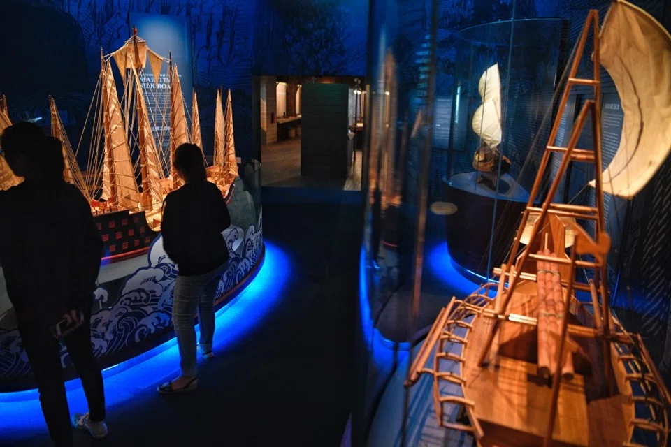 Visitors pass through the Maritime Silk Route Vessels gallery featuring models of boats which have travelled through the route in the past. These include the Chinese Junk (left), Javanese Jong (background right), and Borobudur (right). (SPH Media)