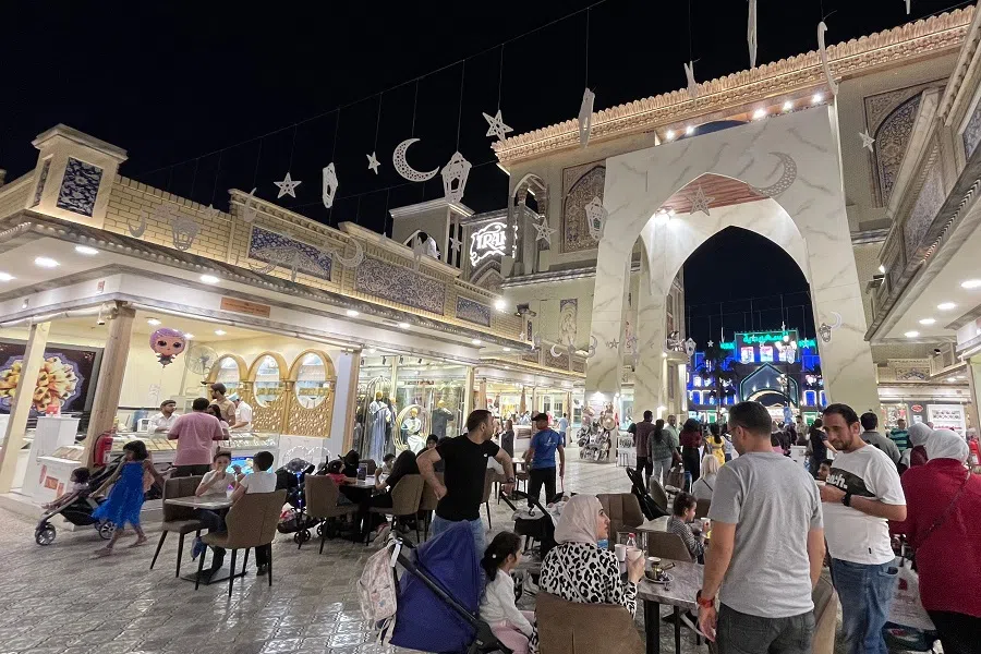 People visit the Global Village, a shopping, dining and entertainment complex in Dubai, United Arab Emirates, on 20 April 2023. (Giuseppe Cacace/AFP)