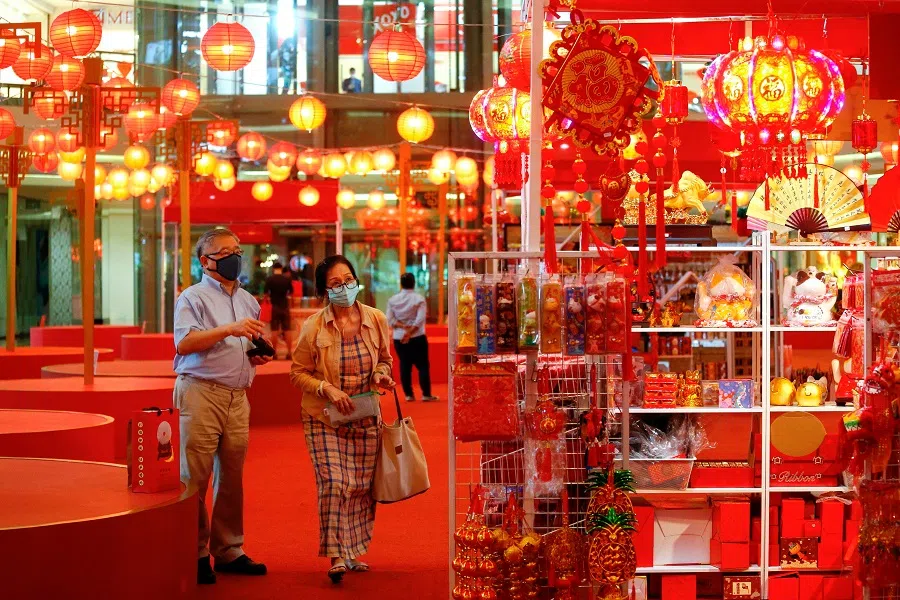 People wearing protective masks shop for decorations at a shopping mall ahead of the Lunar New Year, in Jakarta, Indonesia, 11 February 2021. (Ajeng Dinar Ulfiana/Reuters)