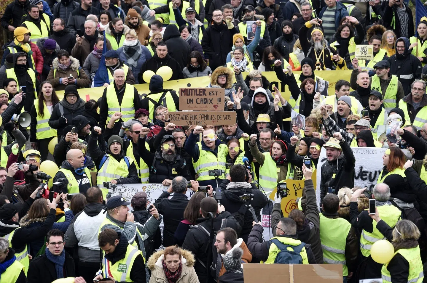 Manuel C., a "Yellow Vest" who was wounded in his left eye by a projectile likely shot by police during a "yellow vest" demonstration on November 16, takes part alongside his wife, one of the movement's leading figures Jerome Rodrigues and other protesters in a march against police violence, on 23 November 2019, in the streets of Valenciennes, northern France. (Francois Lo Presti/AFP)
